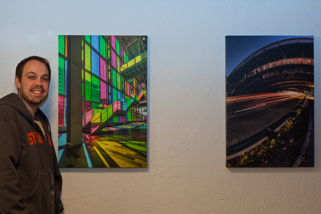APC-04 Urban architecture photographer Brian Matiash poses with some of his Artistic Photo Canvas gallery wraps